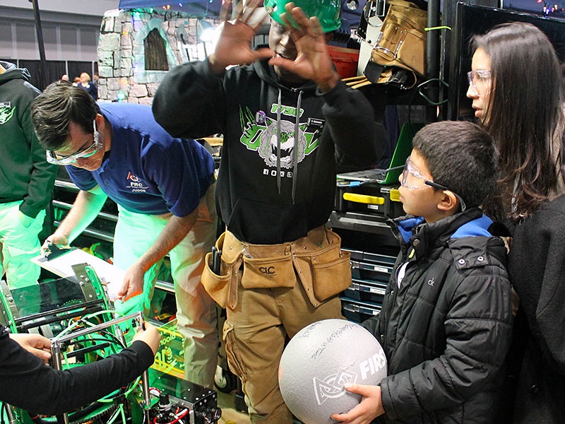 Yuri and Jocelyn inspecting the robots